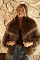 April Fur Jacket — chocolate brown faux fur jacket with oversized collar seated view — Little JC Boutique