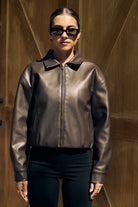 Chocolate brown oversized faux leather jacket front view — Little JC Boutique